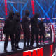 A synonym for Payback is Retribution. This week they've been pretty quiet. On Raw they did appear bigger than ever and attack Dominick and Rey Mysterio but considering what they have done before it was a light attack from them and it seemed like they were trying to send a message. On Smackdown we had complete silence from this group. Is there a reason for that? It may seem like they're getting ready to make a big statement on Sunday. There is another reason I believe they will make an appearance this Sunday so let me share it with you. There's been a lot of speculation that one of these masked figures is NXT's Dominick Dijakovic. On Friday he sent out a tweet which was then deleted that said, "192114040125" which when translated by a cypher spelled out S-U-N-D-A-Y... So far I've everything about Retribution and I think it's time for them to be unmasked and will this Sunday be when all our questions be answered?
