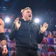 During NXT this week member of the Undisputed Era were attacked one by one leaving just Kyle O'Reilly to face Breezango, he then decided to let Oney Lorcan and Danny Birch face Breezango for the titles instead. During the match a masked figure pushed Fandango off the top rope when the referee wasn't looking. Tyler Breeze sent the ref to check on Fandango and Burch capitalised delivering a low-blow to Breeze. They then performed their finisher and won the tag-team titles. This is a massive win for this team. Did they play dirty or smart? The masked figure joined them in the ring for the celebration, when he unmasked it was none other than Pat McAfee. I'm not surprised he attacked the Undisputed Era as I guess he still has some issues with them but I was shocked he is aligning himself with Lorcan and Burch. This could be very beneficial for all three men. I hope we get to see McAfee back in ring I really enjoyed his last match. 