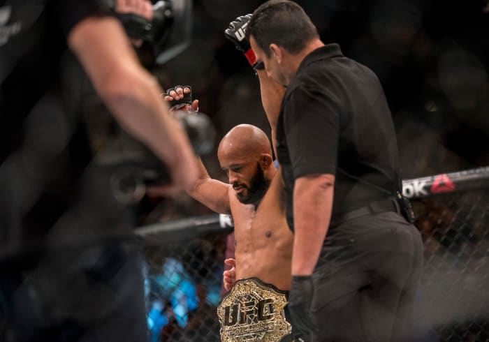 Apr 23, 2016; Las Vegas, NV, USA; Demetrious Johnson (red gloves) reacts after defeating Henry Cejudo (blue gloves) during UFC 197 at MGM Grand Garden Arena. Mandatory Credit: Joshua Dahl-USA TODAY Sports