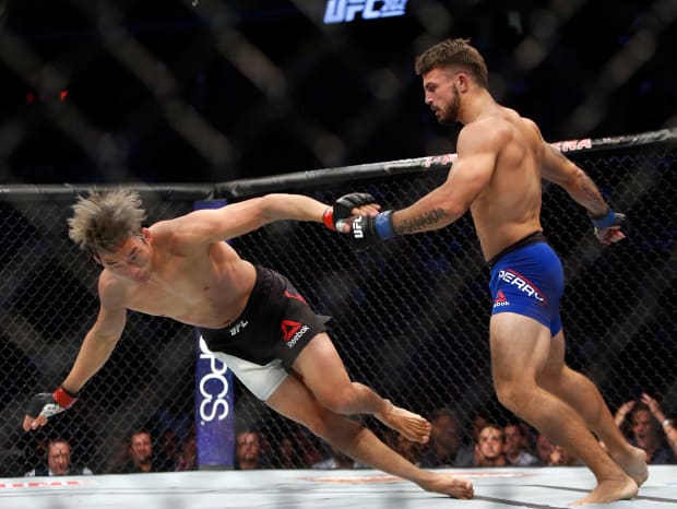 LAS VEGAS, NV - AUGUST 20: Mike Perry (R) sends Hyun Gyu Lim to the canvas during their welterweight bout at the UFC 202 event at T-Mobile Arena on August 20, 2016 in Las Vegas, Nevada. Perry won by first-round TKO. (Photo by Steve Marcus/Getty Images)