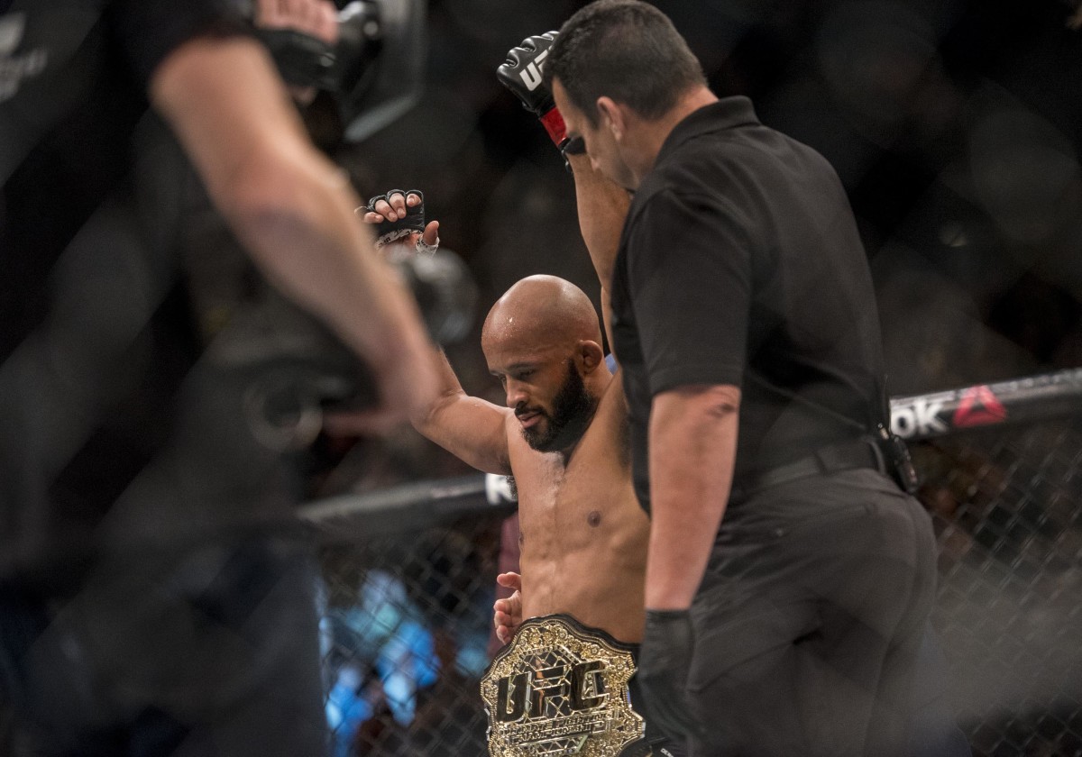 Apr 23, 2016; Las Vegas, NV, USA; Demetrious Johnson (red gloves) reacts after defeating Henry Cejudo (blue gloves) during UFC 197 at MGM Grand Garden Arena. Mandatory Credit: Joshua Dahl-USA TODAY Sports
